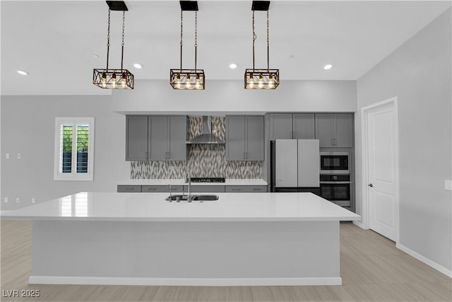 11909 Pippa Ave, Las Vegas, NV 89138 - kitchen featuring gray cabinetry, wall chimney range hood, appliances with stainless steel finishes, light countertops, and recessed lighting