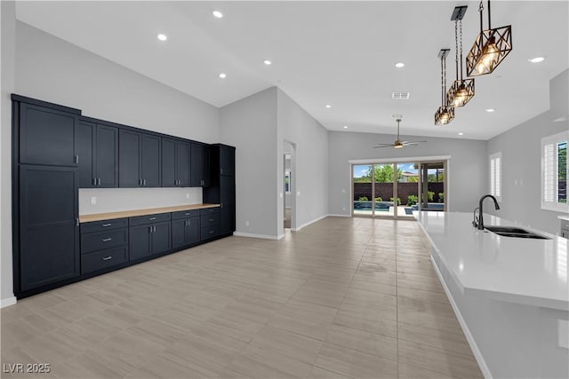 11909 Pippa Ave, Las Vegas, NV 89138 - kitchen featuring vaulted ceiling, ceiling fan, light countertops, pendant lighting, and recessed lighting
