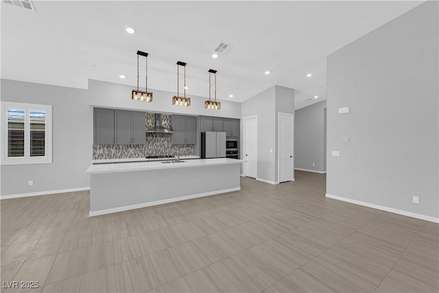 11909 Pippa Ave, Las Vegas, NV 89138 - kitchen featuring gray cabinets, freestanding refrigerator, wall chimney range hood, light countertops, and backsplash