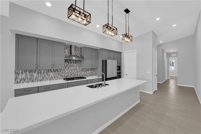 11909 Pippa Ave, Las Vegas, NV 89138 - kitchen with gray cabinetry, wall chimney exhaust hood, backsplash, light countertops, and recessed lighting