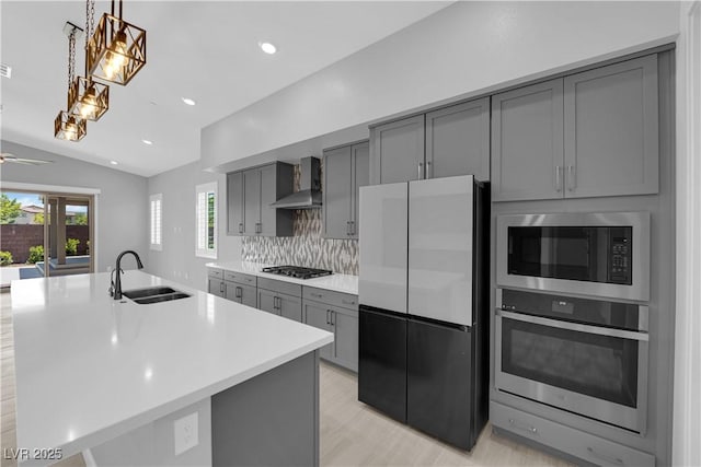 11909 Pippa Ave, Las Vegas, NV 89138 - kitchen featuring appliances with stainless steel finishes, gray cabinets, wall chimney exhaust hood, light countertops, and recessed lighting