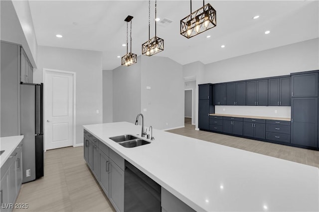 11909 Pippa Ave, Las Vegas, NV 89138 - kitchen featuring dishwasher, light countertops, freestanding refrigerator, decorative light fixtures, and recessed lighting
