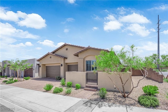 11909 Pippa Ave, Las Vegas, NV 89138 - mediterranean / spanish house with a fenced front yard, stucco siding, a garage, driveway, and a gate
