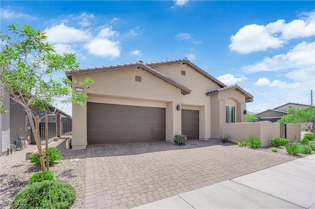 11909 Pippa Ave, Las Vegas, NV 89138 - mediterranean / spanish-style home featuring stucco siding, decorative driveway, a garage, and a tile roof