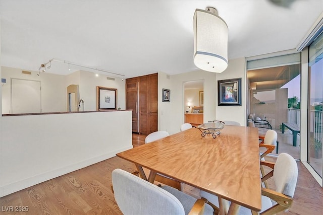 3111 Bel Air Dr Unit 7D, Las Vegas, NV 89109 - dining space featuring light wood-style floors and rail lighting