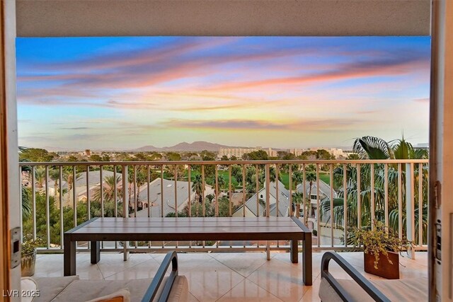 3111 Bel Air Dr Unit 7D, Las Vegas, NV 89109 - balcony at dusk featuring a mountain view