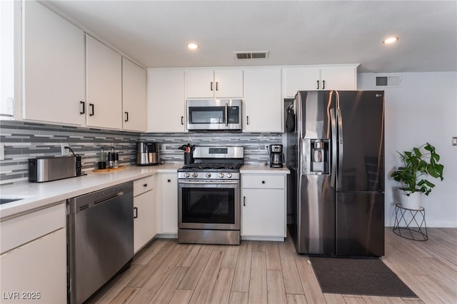 2990 Carnelian St, Las Vegas, NV 89121 - kitchen featuring stainless steel appliances, light countertops, light wood-style flooring, and recessed lighting