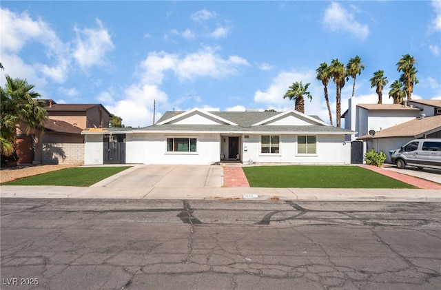 2990 Carnelian St, Las Vegas, NV 89121 - ranch-style house with a front yard, stucco siding, and concrete driveway