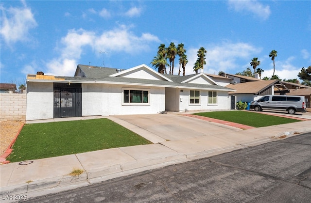 2990 Carnelian St, Las Vegas, NV 89121 - view of front of property featuring stucco siding and a front lawn