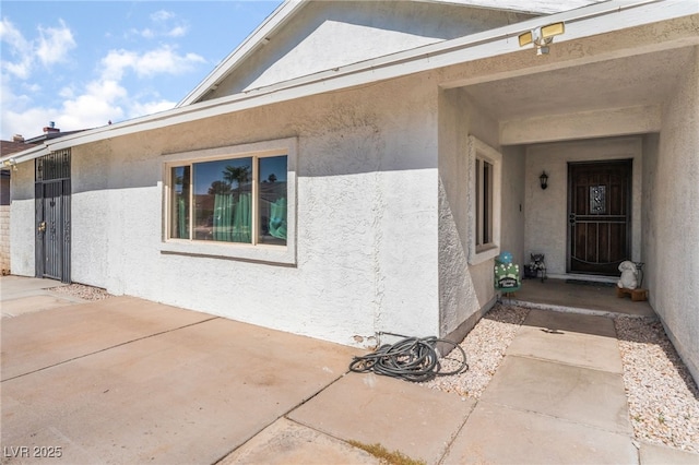 2990 Carnelian St, Las Vegas, NV 89121 - doorway to property featuring stucco siding and a patio
