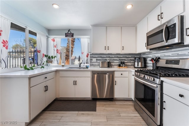 2990 Carnelian St, Las Vegas, NV 89121 - kitchen with stainless steel appliances, light countertops, recessed lighting, backsplash, and white cabinetry
