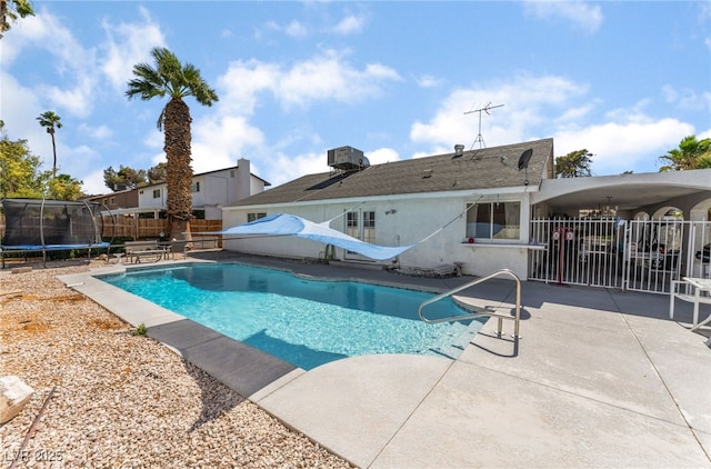 2990 Carnelian St, Las Vegas, NV 89121 - view of swimming pool featuring a trampoline, a patio area, and a fenced backyard