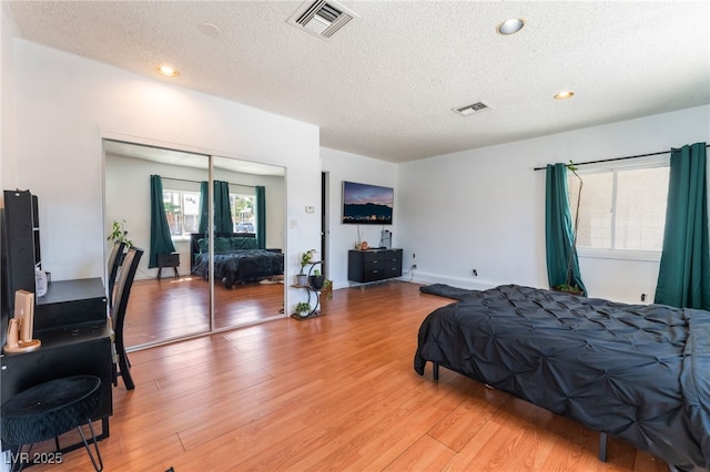 2990 Carnelian St, Las Vegas, NV 89121 - bedroom featuring a textured ceiling, light wood finished floors, a closet, and recessed lighting