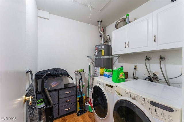 2990 Carnelian St, Las Vegas, NV 89121 - laundry room with strapped water heater, washer and dryer, cabinet space, and light wood-style flooring