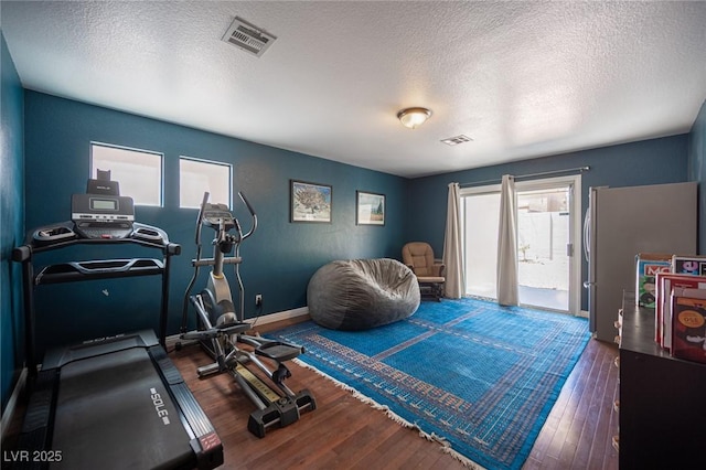 7021 Salt Marsh Ct, Las Vegas, NV 89148 - workout room with wood finished floors and a textured ceiling