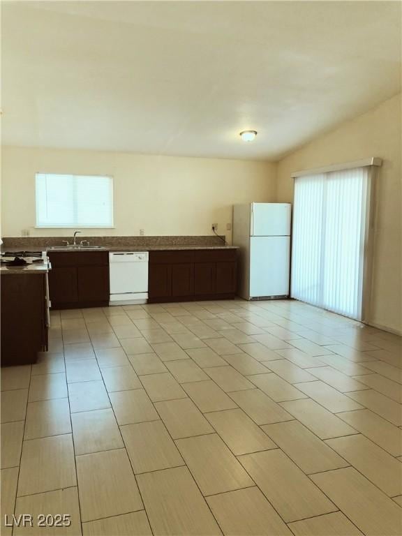 6196 W University Ave, Las Vegas, NV 89103 - kitchen featuring white appliances, dark brown cabinetry, and light tile patterned floors
