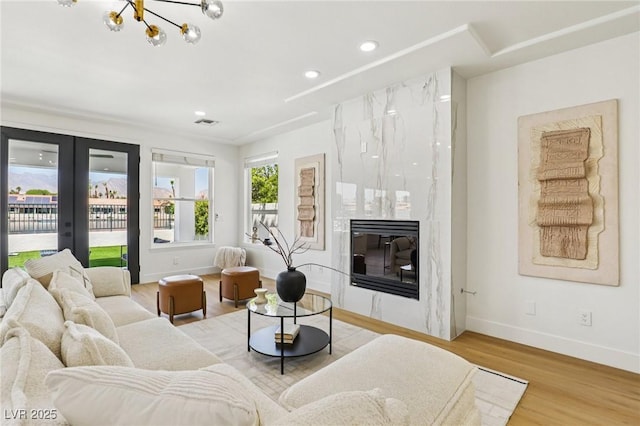 2469 Sun Reef Rd, Las Vegas, NV 89128 - living area featuring wood finished floors, recessed lighting, a fireplace, french doors, and a chandelier