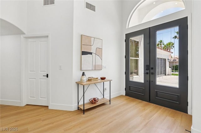 2469 Sun Reef Rd, Las Vegas, NV 89128 - entrance foyer featuring french doors, wood finished floors, a high ceiling, and arched walkways