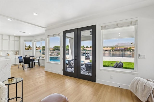 2469 Sun Reef Rd, Las Vegas, NV 89128 - doorway to outside with french doors, light wood finished floors, recessed lighting, and a water view