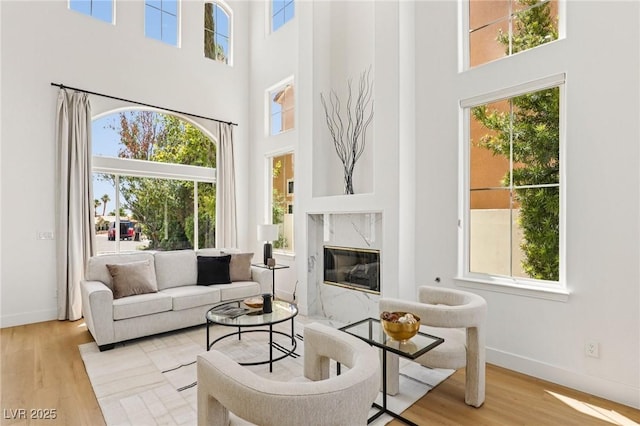 2469 Sun Reef Rd, Las Vegas, NV 89128 - living area featuring a high ceiling, plenty of natural light, wood finished floors, and a premium fireplace
