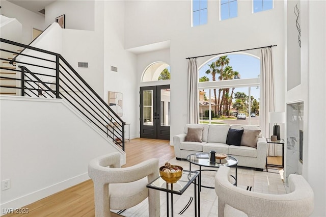 2469 Sun Reef Rd, Las Vegas, NV 89128 - living area with a high ceiling, wood finished floors, stairs, and french doors