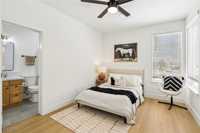 2469 Sun Reef Rd, Las Vegas, NV 89128 - bedroom with light wood-type flooring, ensuite bath, and ceiling fan