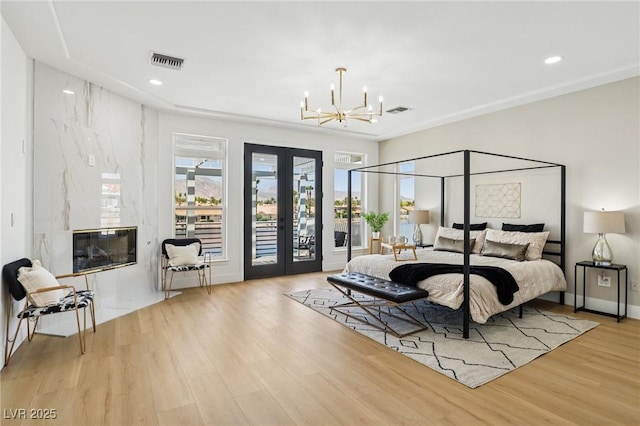 2469 Sun Reef Rd, Las Vegas, NV 89128 - bedroom with access to outside, a chandelier, french doors, wood finished floors, and recessed lighting