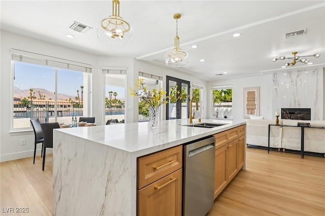 2469 Sun Reef Rd, Las Vegas, NV 89128 - kitchen featuring stainless steel dishwasher, light wood-style flooring, recessed lighting, pendant lighting, and a center island with sink