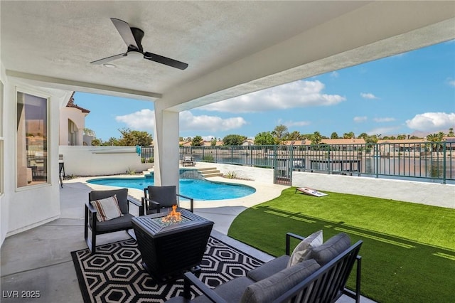 2469 Sun Reef Rd, Las Vegas, NV 89128 - fenced backyard featuring a water view, an outdoor fire pit, a ceiling fan, and a patio area