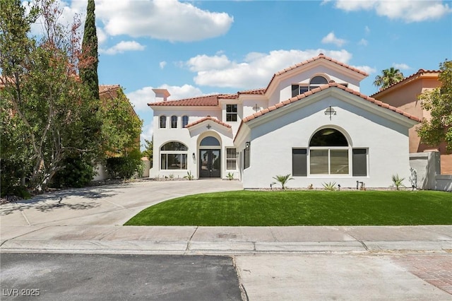 2469 Sun Reef Rd, Las Vegas, NV 89128 - mediterranean / spanish-style home featuring a front yard, stucco siding, curved driveway, and a tiled roof
