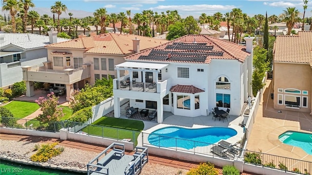 2469 Sun Reef Rd, Las Vegas, NV 89128 - back of property with a balcony, a fenced backyard, stucco siding, a tiled roof, and a patio area