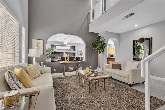 4435 Peaceful Harbor St, Las Vegas, NV 89129 - living area with arched walkways, a towering ceiling, ceiling fan, healthy amount of natural light, and recessed lighting
