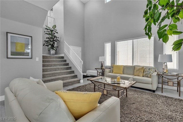 4435 Peaceful Harbor St, Las Vegas, NV 89129 - living room with stairs, a towering ceiling, and wood finished floors