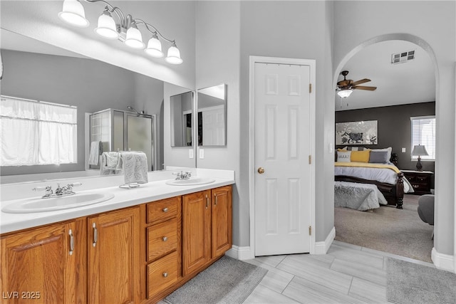 4435 Peaceful Harbor St, Las Vegas, NV 89129 - full bathroom featuring ceiling fan, double vanity, a shower stall, and ensuite bath