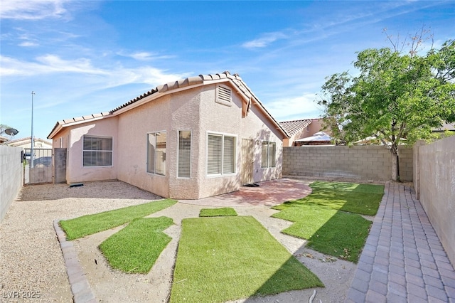 7920 Turtle Island Ct, Las Vegas, NV 89129 - back of property featuring a fenced backyard, stucco siding, a patio area, and a tile roof