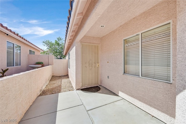 7920 Turtle Island Ct, Las Vegas, NV 89129 - view of exterior entry with stucco siding and a patio area
