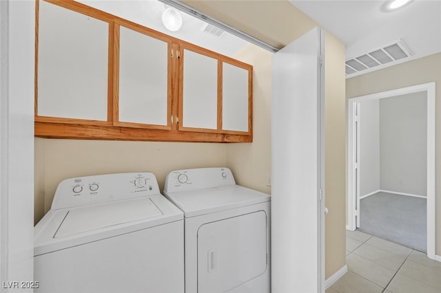 7920 Turtle Island Ct, Las Vegas, NV 89129 - washroom with washing machine and clothes dryer, cabinet space, light tile patterned floors, and light carpet