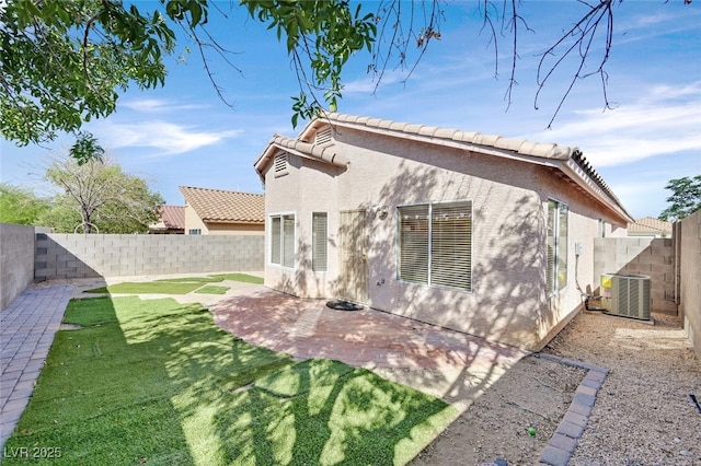 7920 Turtle Island Ct, Las Vegas, NV 89129 - rear view of property featuring a fenced backyard, stucco siding, a patio, and a tiled roof