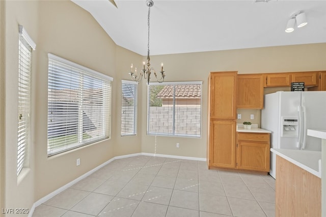 7920 Turtle Island Ct, Las Vegas, NV 89129 - kitchen with white refrigerator with ice dispenser, a chandelier, light countertops, hanging light fixtures, and healthy amount of natural light