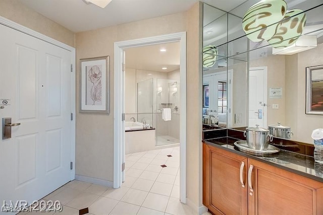 135 E Harmon Ave Unit 1703, Las Vegas, NV 89109 - full bath featuring a stall shower, tile patterned flooring, a bath, and vanity