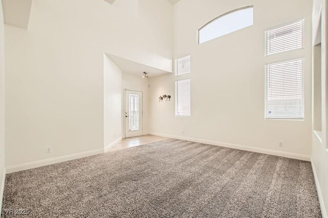 10413 Rising Harbor Ave, Las Vegas, NV 89129 - carpeted empty room with a high ceiling and baseboards