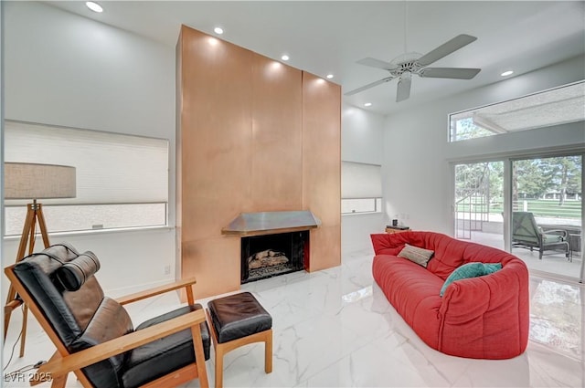2851 Queens Courtyard Dr, Las Vegas, NV 89109 - living area with ceiling fan, marble tiled floors, recessed lighting, and a fireplace
