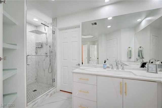 2851 Queens Courtyard Dr, Las Vegas, NV 89109 - bathroom with a marble finish shower, recessed lighting, marble look tile flooring, and vanity