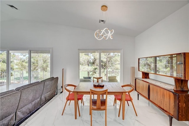 2851 Queens Courtyard Dr, Las Vegas, NV 89109 - dining area featuring lofted ceiling, light marble finish flooring, and a chandelier