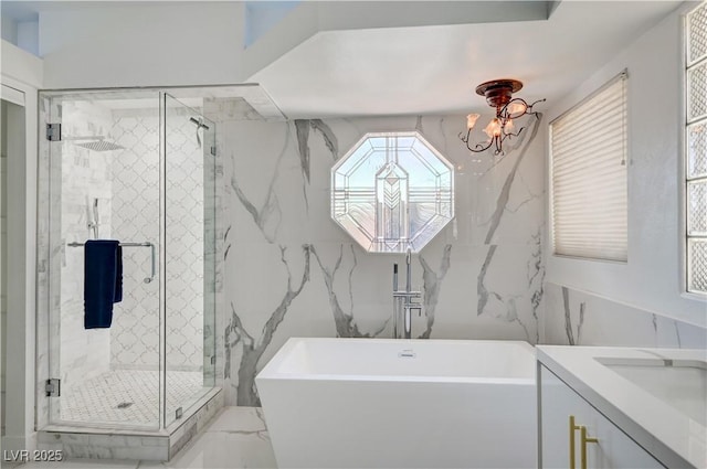2851 Queens Courtyard Dr, Las Vegas, NV 89109 - full bathroom featuring a freestanding bath, a shower stall, vanity, tile walls, and plenty of natural light