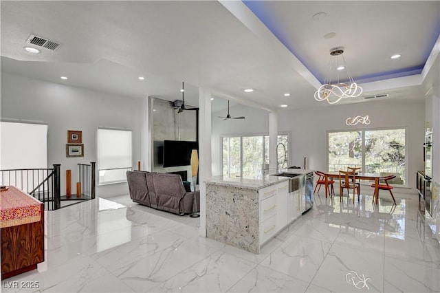 2851 Queens Courtyard Dr, Las Vegas, NV 89109 - kitchen featuring white cabinetry, a chandelier, light stone counters, a ceiling fan, and recessed lighting