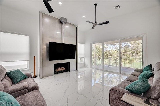2851 Queens Courtyard Dr, Las Vegas, NV 89109 - living room featuring a ceiling fan, marble tiled flooring, a large fireplace, recessed lighting, and a high ceiling