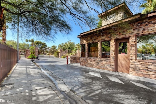 2851 Queens Courtyard Dr, Las Vegas, NV 89109 - view of road with a gate, a gated entry, and curbs