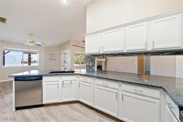 2950 Winchester Ave, Pahrump, NV 89048 - kitchen with stainless steel dishwasher, light wood-style floors, a ceiling fan, and white cabinetry