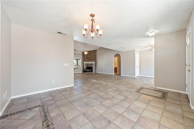 2950 Winchester Ave, Pahrump, NV 89048 - unfurnished living room with ceiling fan, a chandelier, arched walkways, and a fireplace